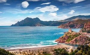 a view of a beach with mountains and the ocean at Résidence Le Porto in Porto Ota +5 photos