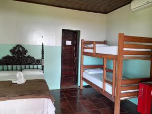 a bedroom with two bunk beds in a room at Pousada Marajo in Salvaterra
