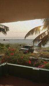 a truck parked on the beach near the water at Summer Beach House in Alleppey