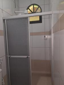 a shower with a glass door in a bathroom at Pousada Marajo in Salvaterra +58 photos