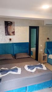 a bedroom with a bed with towels on it at PARAVANHouse in Constanţa