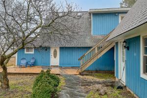 a blue house with a blue door and a chair at Chautauqua Lake Views! Bemus Point Getaway in Bemus Point