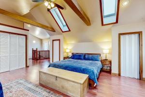 a bedroom with a bed with a blue bedspread at Chautauqua Lake Views! Bemus Point Getaway in Bemus Point