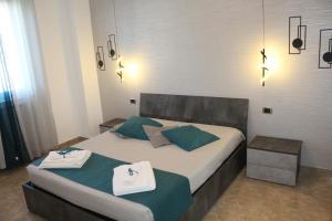 a bedroom with a bed with towels on it at Luca's House - Villa sul mare con piscina in Giovinazzo +42 photos
