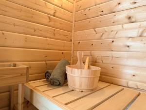 a wooden sauna with a stuffed animal on a shelf at Pure Wellness Bungalows 52 Sauna&Hottub in Ewijk