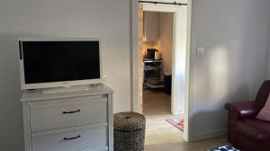 a television on a dresser in a living room at Casa Bueu Pontevedra in Bueu