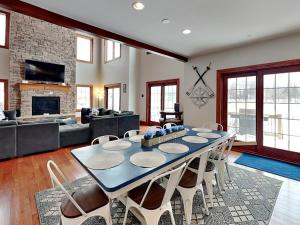 a living room with a table and a couch at Limitless Joy in Swanton +24 photos