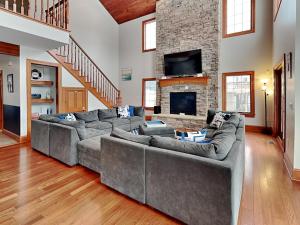 a living room with two couches and a fireplace at Limitless Joy in Swanton