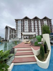 a resort with a pool and a building at Antara Residential Condominium in Talisay