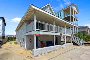 a house with a balcony on the side of it at Sand Dollar Suites 1 in Carolina Beach