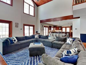 a large living room with couches and a rug at Limitless Joy in Swanton