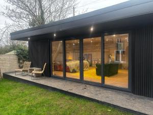 a glass house with a bedroom in the background at The Cabin in St. Ives
