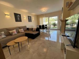 a living room with a couch and a table at 32 Salamandre in Les tres Cales