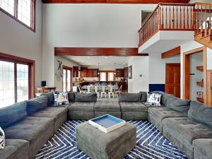 a large living room with a couch and a table at Limitless Joy in Swanton