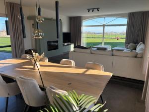 a living room with a wooden table and a couch at 't Caeneghems Goed in Tielt