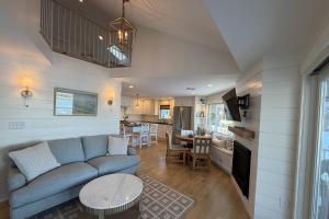 a living room with a blue couch and a kitchen at Perfectly Scitu8ed - Scituate in Scituate