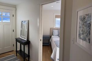 a bedroom with a mirror and a bed in it at Perfectly Scitu8ed - Scituate in Scituate +35 photos