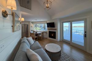 a living room with a couch and a fireplace at Perfectly Scitu8ed - Scituate in Scituate