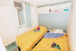 a small room with two beds in it at Camping La Pointe du Talud in Ploemeur
