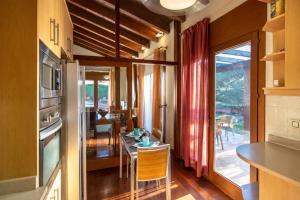 a kitchen with a table and a dining room at Catalunya Casas A Costa Brava gem - only a few minutes to the beach! in Vidreres