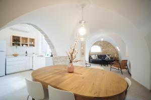 a kitchen and dining room with a wooden table and chairs at חקל תפוחין 1 - Hakal-Tapuchin 1 in Safed +39 photos