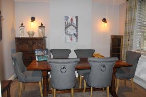 a dining room with a wooden table and chairs at No 1 Chapel Row in Bakewell