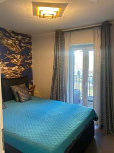 a bedroom with a bed with a blue comforter at Villa Kehrwieder Göhren in Göhren