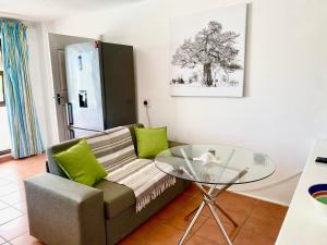 a living room with a couch and a glass table at Seaview in Hout Bay