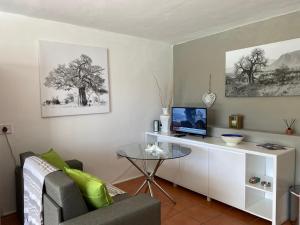 a living room with a desk with a laptop on it at Seaview in Hout Bay