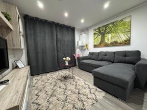 a living room with a couch and a table at Hidden Apartment in Miercurea-Ciuc