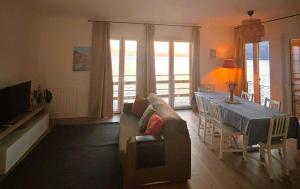 a living room with a couch and a table at M'illumino d'immenso - MONEGLIA APARTMENTS in Moneglia