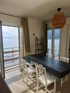 a dining room with a table and chairs and the ocean at M'illumino d'immenso - MONEGLIA APARTMENTS in Moneglia