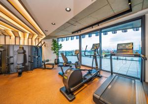 a gym with treadmills and exercise equipment in a building at The Zipper Hotel und Apartments in Düsseldorf