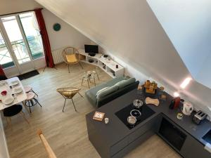 an overhead view of a living room with a couch at Alizée in Granville +10 photos