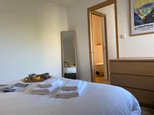 a bedroom with a bed with two towels on it at Alizée in Granville