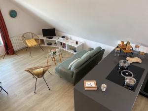 a living room with a couch and a table at Alizée in Granville