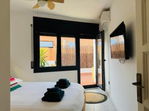 a bedroom with a bed with blue towels on it at Casa Dolce Vita in Palamós