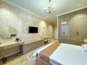 a bedroom with a large bed and a television at River Hotel Restaurant in Quba