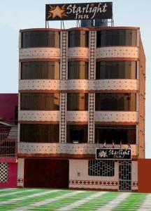 a tall building with a sign on top of it at Starlight Inn in Pisco