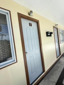 a room with a white door and a window at Belechl Ranch Studio Rental - Cozy Compact Room with Private Bathroom in Koror