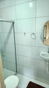 a bathroom with a toilet and a sink at Suíte Conforto - Leve, Prático e Acolhedor in Itacaré +6 photos