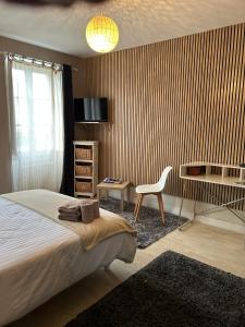 a bedroom with a bed and a desk and a chair at Casa 17 Confolens in Confolens