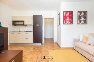 a living room with a couch and a kitchen at Elite Collection Domo Mea Private Pool in Olbia
