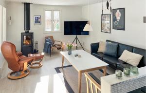 a living room with a couch and a table at 3 Bedroom Gorgeous Home In Stubbekøbing in Stubbekøbing