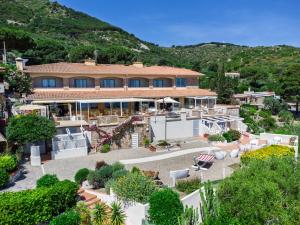 a large house with a garden in front of it at Hotel L'Arenella in Giglio Porto +24 photos