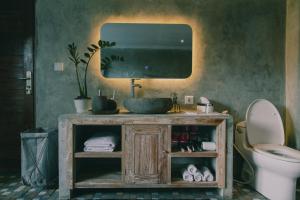 a bathroom with a sink and a toilet and a mirror at Bedugulhome in Bedugul +48 photos