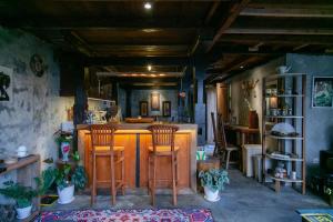 a kitchen with a bar with wooden stools at Bedugulhome in Bedugul