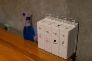 a row of white appliances next to a blue bottle at Bedugulhome in Bedugul