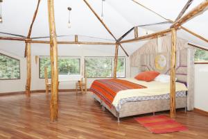 a bedroom with a bed in a tent at Caisae Eco-Lodge in San Antonio