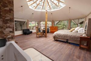 a bedroom with a bed and a large chandelier at Caisae Eco-Lodge in San Antonio